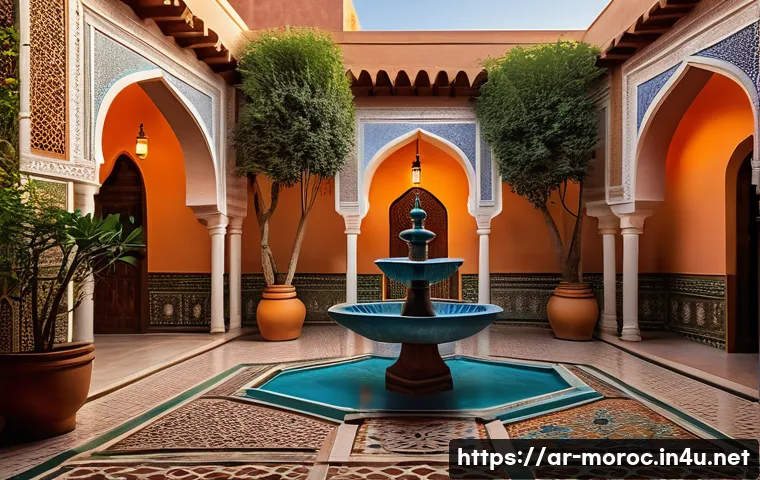 모로코 리야드 숙소 - A traditional Moroccan riad courtyard at sunset, featuring intricate colorful zellij tilework on wal...